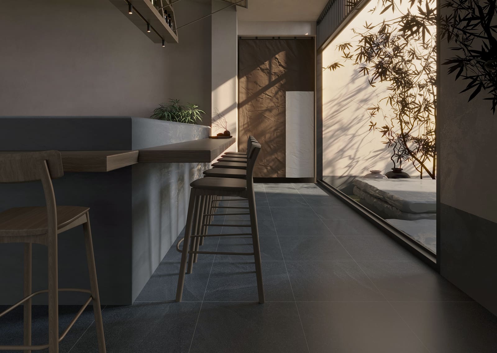 Full-height sintered stone wall with continuous veining in a large commercial interior