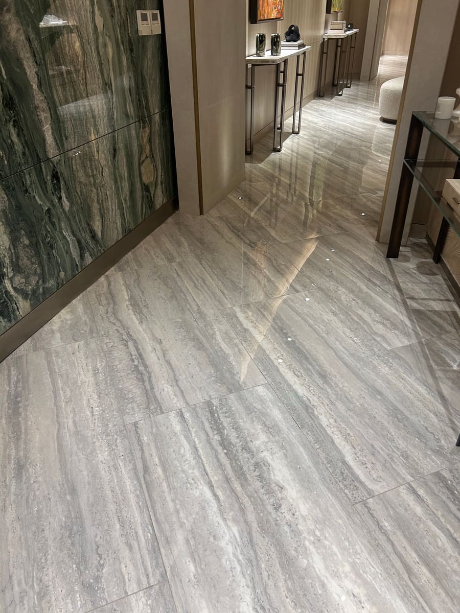 Veined large-format porcelain wall and floor pairing in a lobby